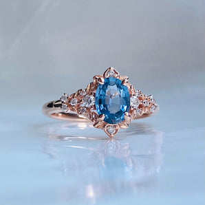 fantasy design blue sapphire ring in rose gold wkith diamonds. filigree vintage inspired delicate unique engagement ring
