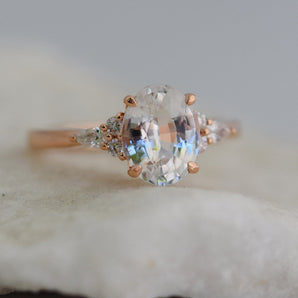 white sapphire engagement ring with diamond clusters rose gold