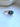 Elegant asymmetrical emerald and tanzanite birthstone ring with botanical gold details