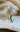 Three-quarter view of a 2 carat green marquise lab-grown diamond engagement ring by EidelPrecious, accented with small white lab diamonds in 14k yellow gold