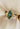 Fiore Alpha + Beta 2ct marquise green lab diamond engagement ring in 14k yellow gold, with hummingbird-inspired details and lab diamond accents, on ivory silk.