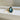 Fiore Alpha + Beta engagement ring featuring a 4.5ct natural Amazon teal pear sapphire, lab diamonds, and a botanical 14k yellow gold setting.