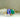 Floral Toi et Moi ring with emerald cut tanzanite and pear shaped emerald in solid 14K gold

